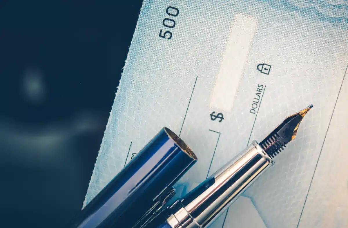 A pen is sitting on top of a legal check.