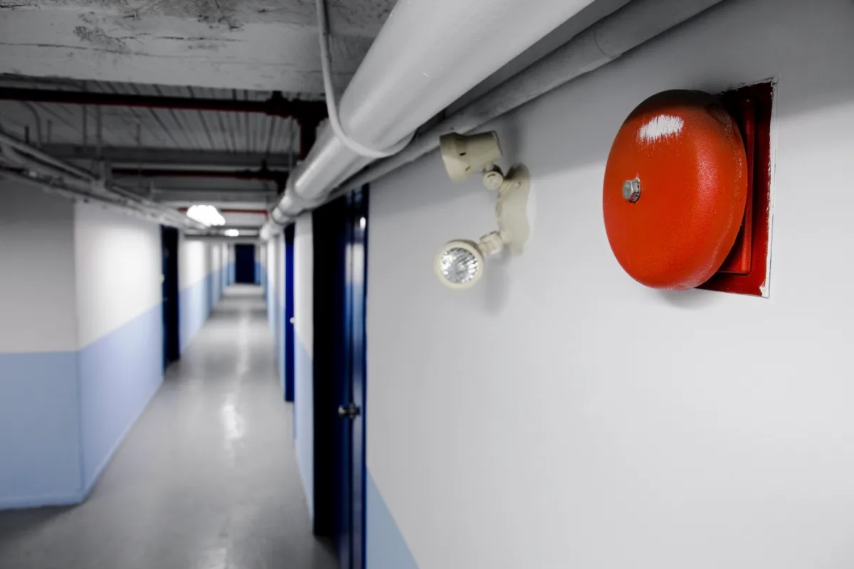 A hallway with a red light on the wall specifically designed to create charges and provoke constitutional examinations, such as when a driver encounters a red traffic light.