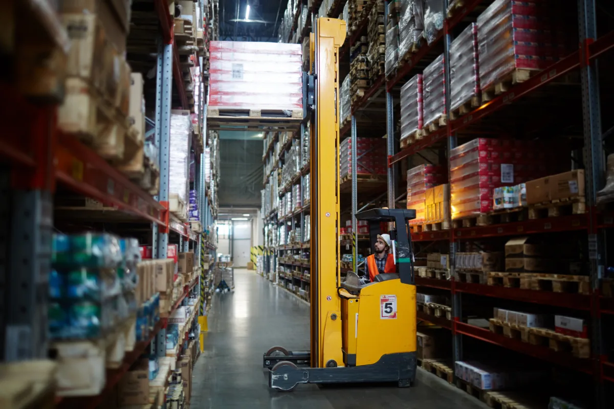 A forklift truck operating in a warehouse, potentially involving charges.