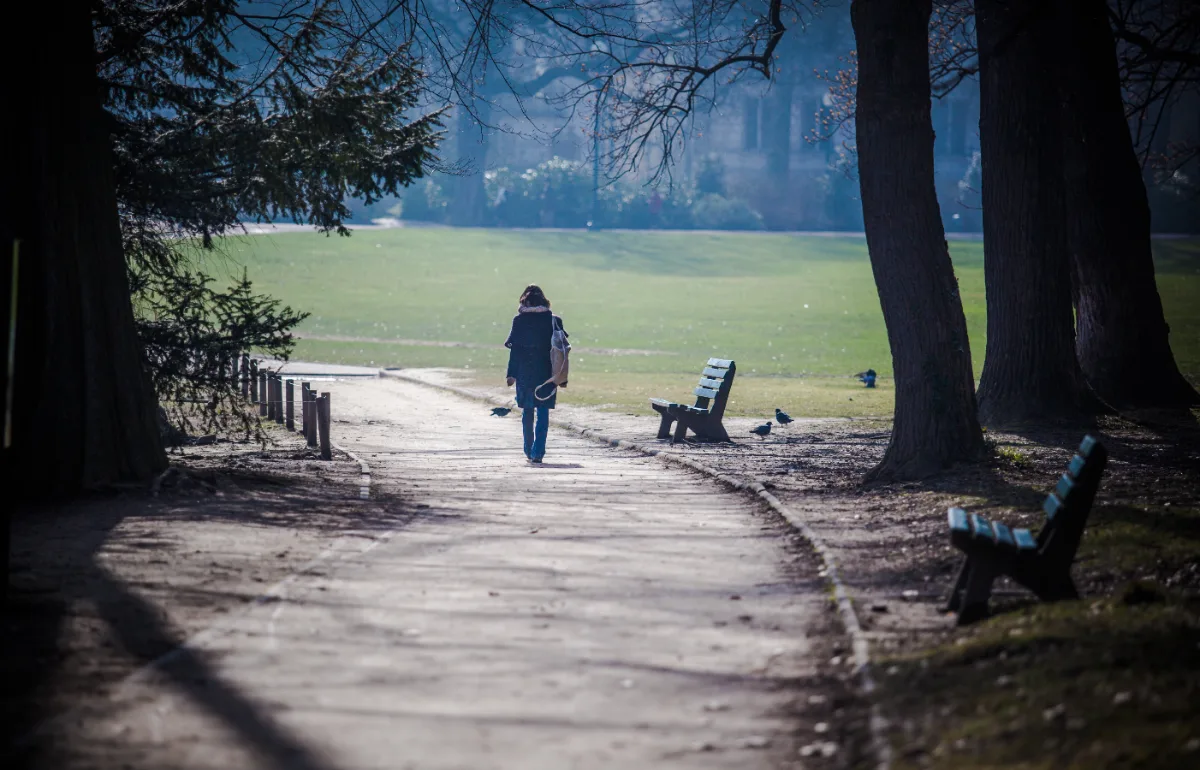 A person walking down a path in a park, oblivious to the constitutional rights protecting him from any probationary charges.